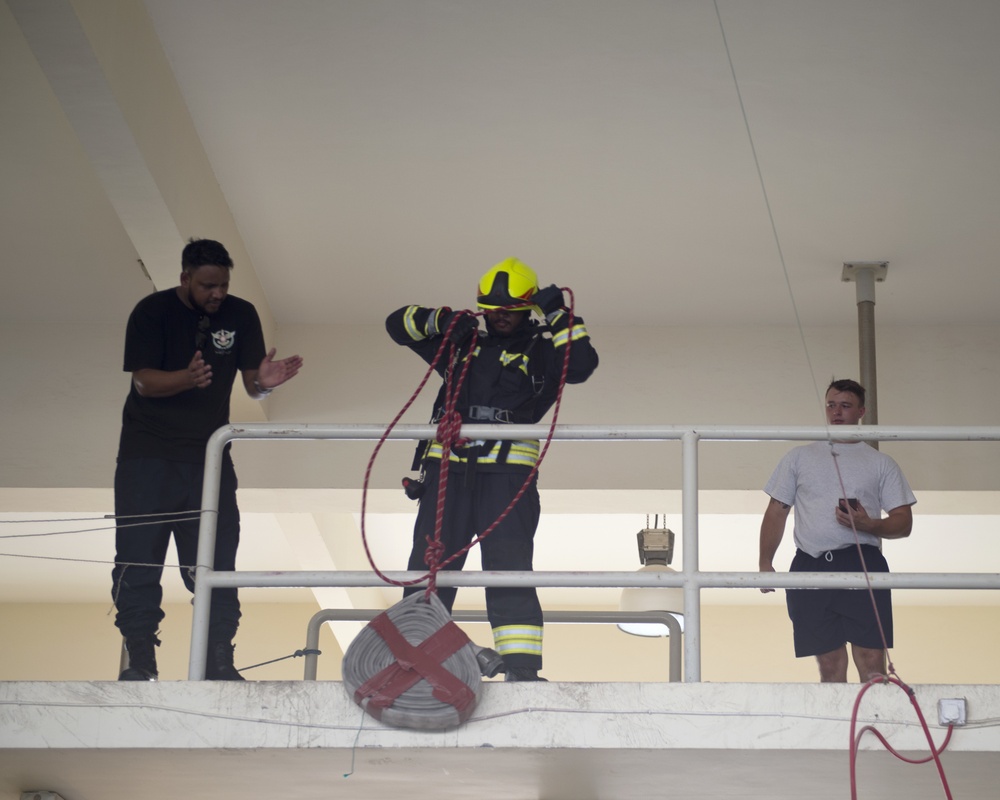 Firefighters with the U.S. Air Force and Qatar Emiri Air Force complete a firefighter combat challenge at Al Udeid Air Base