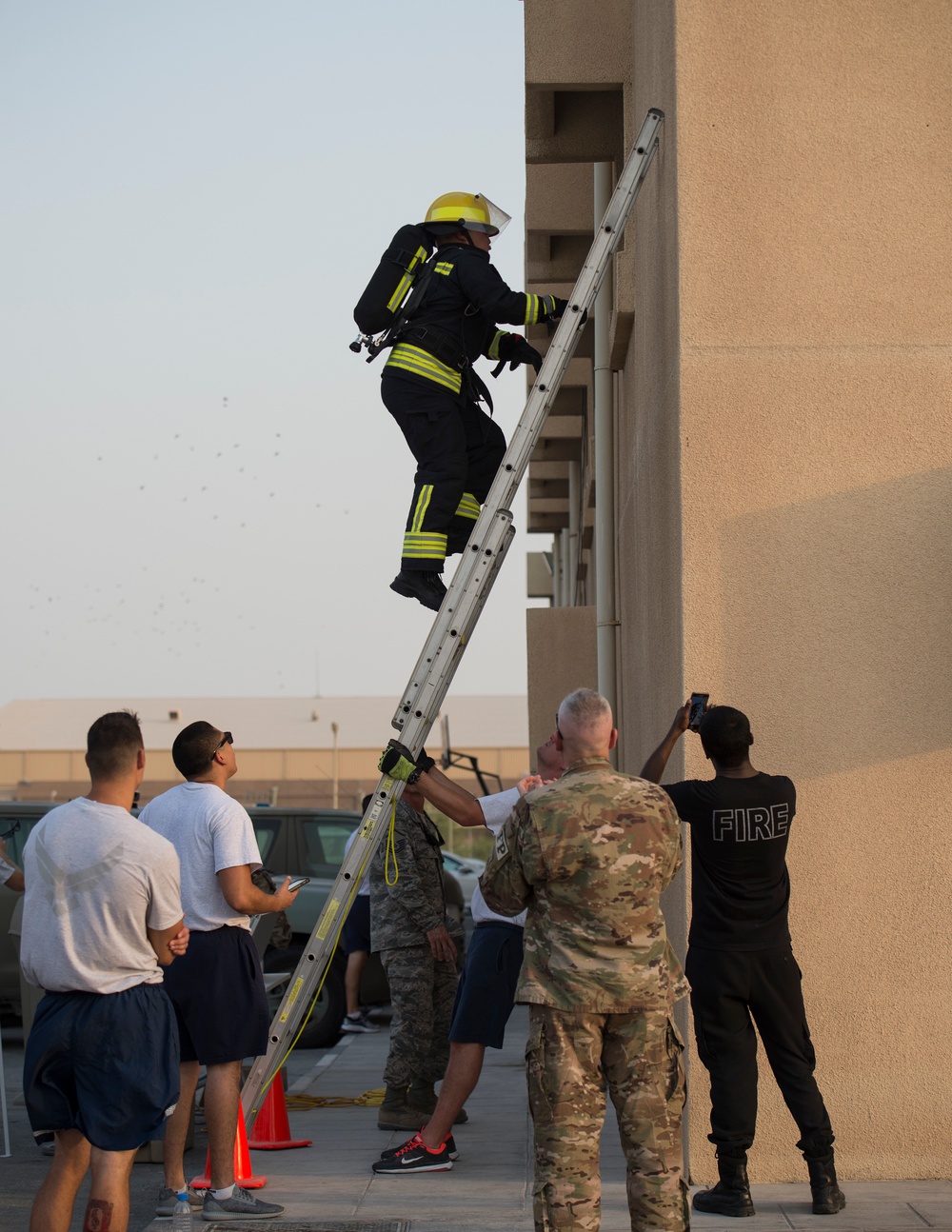 Firefighters with the U.S. Air Force and Qatar Emiri Air Force complete a firefighter combat challenge at Al Udeid Air Base