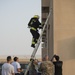 Firefighters with the U.S. Air Force and Qatar Emiri Air Force complete a firefighter combat challenge at Al Udeid Air Base