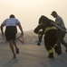 Firefighters with the U.S. Air Force and Qatar Emiri Air Force complete a firefighter combat challenge at Al Udeid Air Base