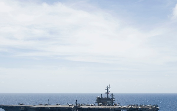 The Japanese Maritime Self-Defense Force ship JS Sazanami (DD-113) steams along side the Nimitz-class aircraft carrier USS Ronald Reagan (CVN 76)