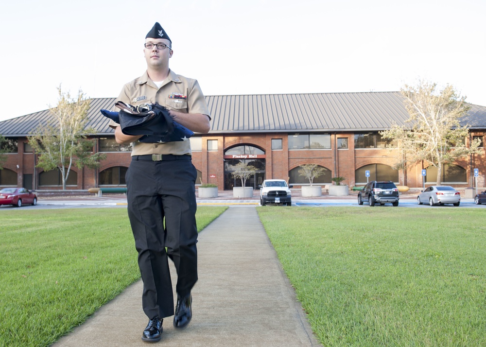 171003-N-LI612-004 KINGS BAY, Ga. (Oct. 3, 2017) Yeoman Submarine 2nd Class Ethan Faircloth raises the flag to half-mast during morning colors on Naval Submarine Base Kings Bay. NSBKB is the east coast home to the Ohio-class submarines. (U.S. Navy photo b