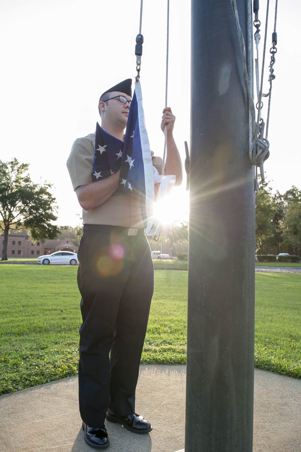 171003-N-LI612-021 KINGS BAY, Ga. (Oct. 3, 2017) Yeoman Submarine 2nd Class Ethan Faircloth raises the flag to half-mast during morning colors on Naval Submarine Base Kings Bay. NSBKB is the east coast home to the Ohio-class submarines. (U.S. Navy photo b