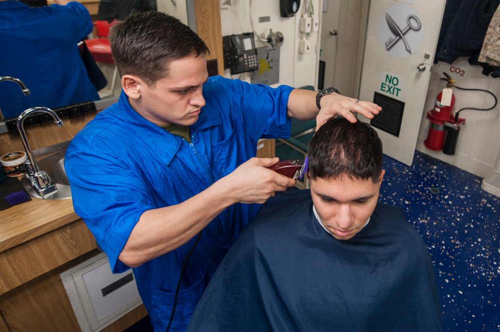 USS America Marine cuts hair