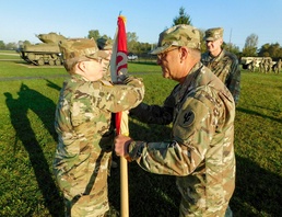 Command Sgt. Maj. Ploeger Passes the Colors to Col. Wood one Last Time During Her Change of Command Ceremony