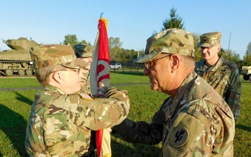 Command Sgt. Maj. Ploeger Passes the Colors to Col. Wood one Last Time During Her Change of Command Ceremony