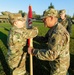 Command Sgt. Maj. Ploeger Passes the Colors to Col. Wood one Last Time During Her Change of Command Ceremony