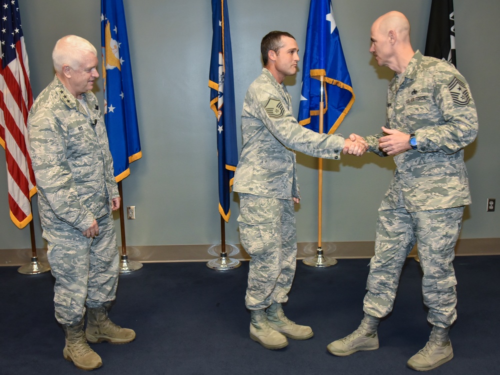 Command Chief Anderson Presents Coin during Visit To 117 ARW