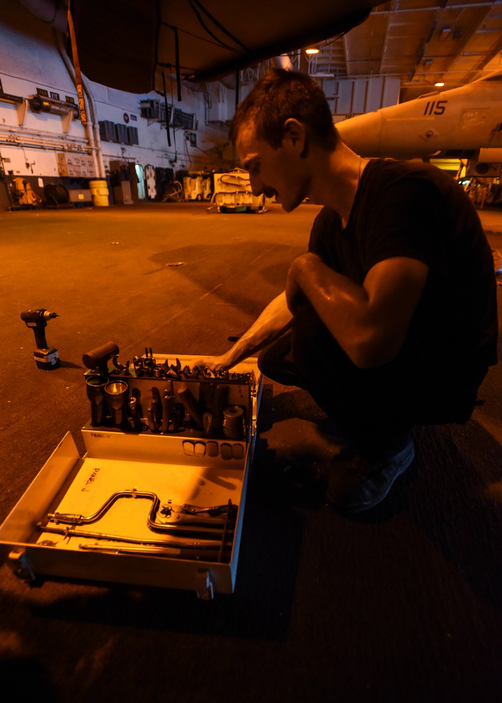 Sailor Looks Through Toolbox