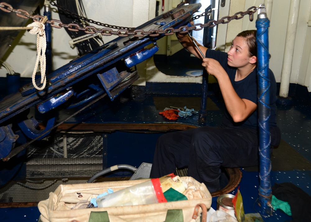 Sailor Performs Maintenance On Hatch