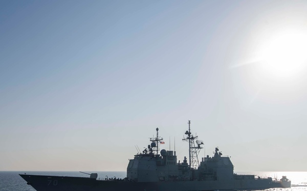 Pearl Harbor steams alongside Lake Erie during strait transit