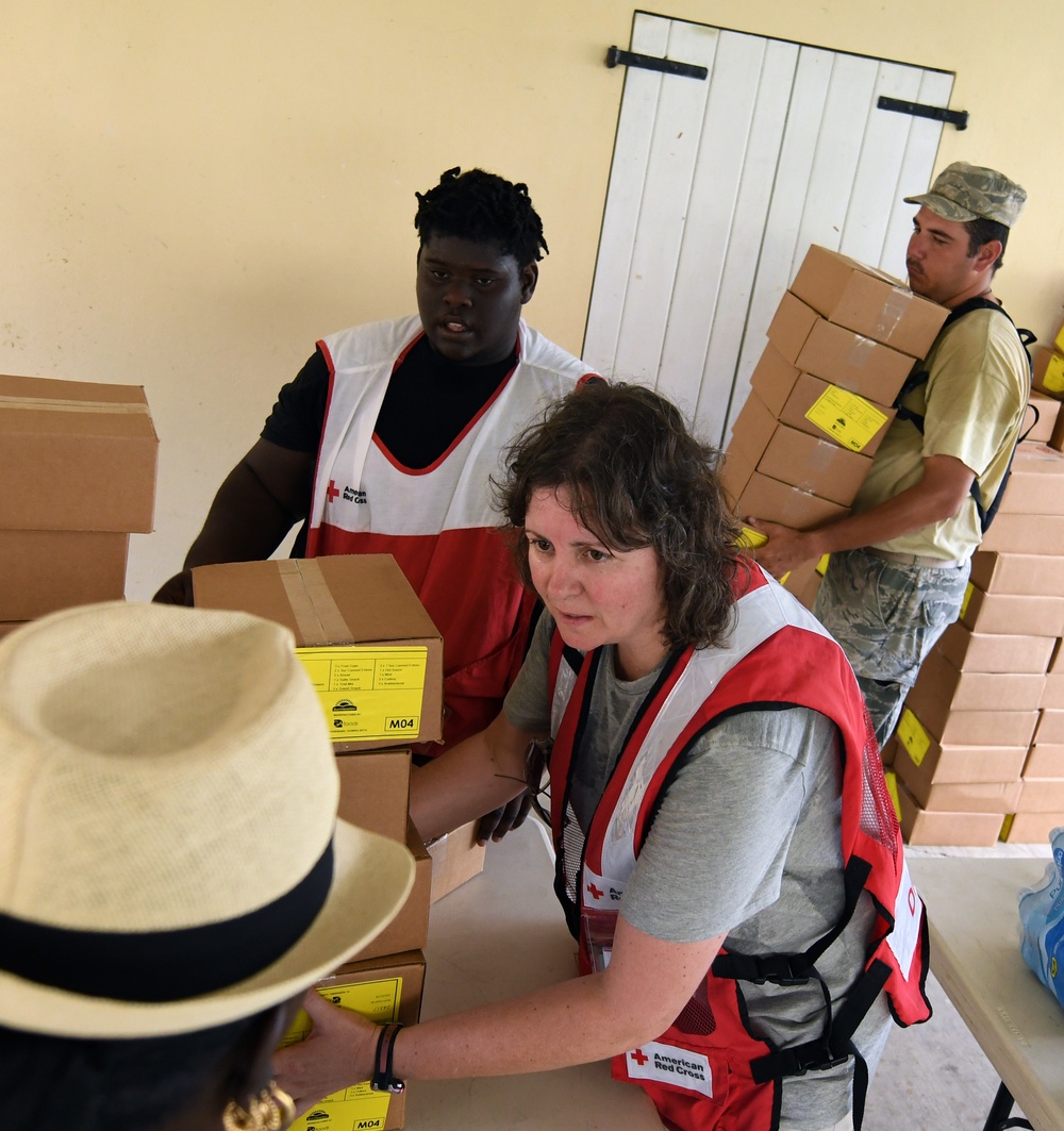 Red Cross Volunteers Help Hand Out Supplies to Local Residents