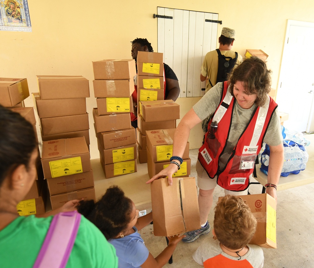 Red Cross Volunteers Help Hand Out Supplies to Local Residents