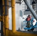 Sailors paint the ship.