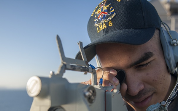 USS America Sailors measure ship’s bearing