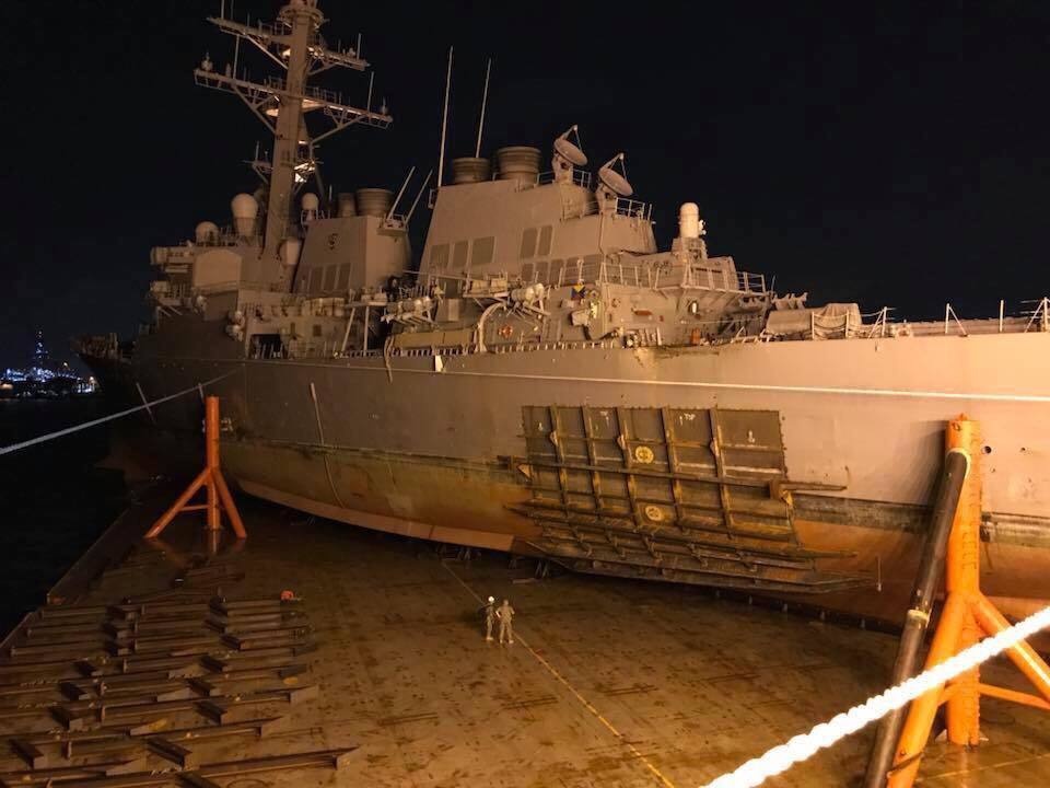 USS John S. McCain moves to heavy lift
