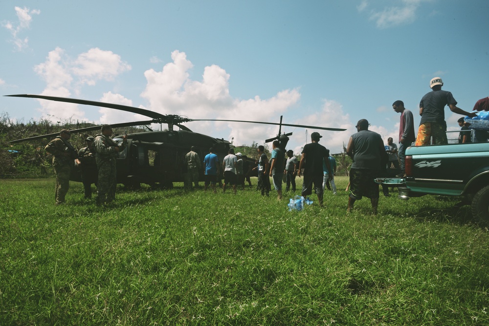Hurricane Maria Survivors Help Unload Food &amp; Water