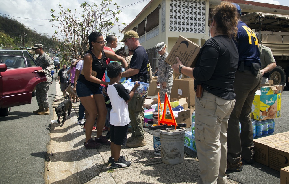 Families receive food and water in Toa Baja