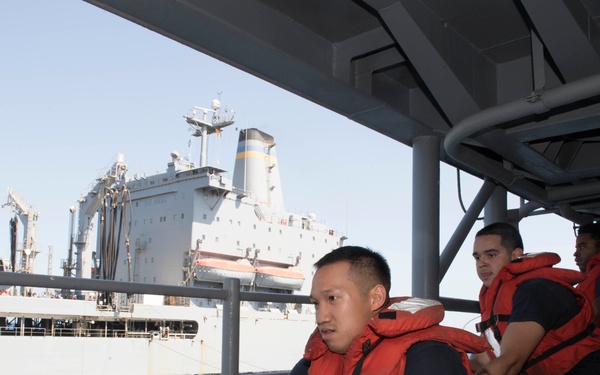 USS Lake Erie (CG 70) Sailors handle lines during RAS