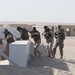Soldiers from Kuwait's 55th Battalion move to clear a mock village
