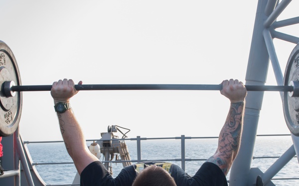 USS Lake Erie (CG 70) Sailor works out