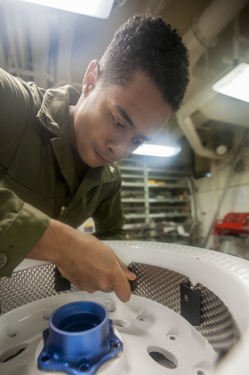 USS America Marine assembles heat shield insulator
