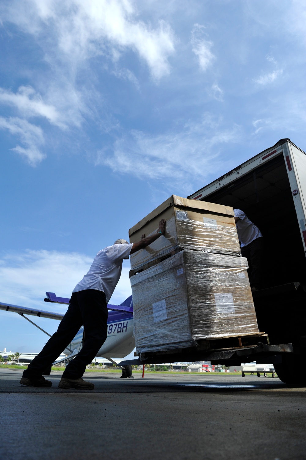 Volunteers and federal workers unload pallets of infant care items for distribution to Puerto Rican families in Vieques impacted by Hurricane Maria