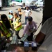 Secretary of the Puerto Rico Department of Family, federal workers, and volunteers prepare infant goods for distribution to families in need