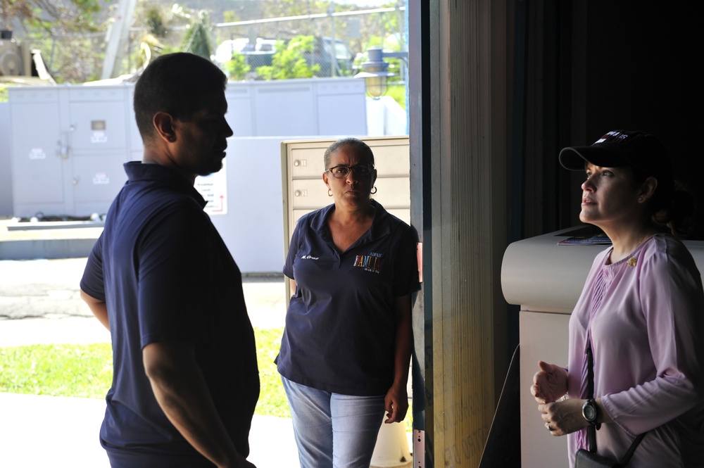 Secretary of the Puerto Rico Department of Family and responders unload infant care goods for distribution to families in need