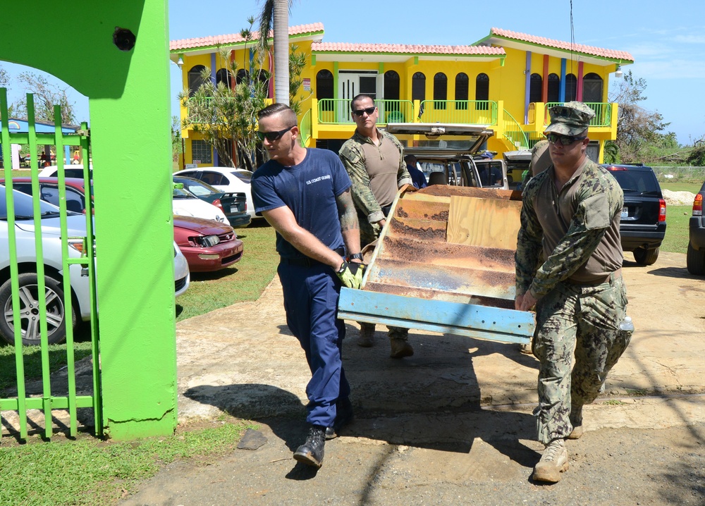 Coast Guardsmen help clean up orphanage in Aguadilla, Puerto Rico, after Hurricane Maria