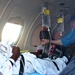 A Medical Flight Crew Member Prepares a Patient for Transport