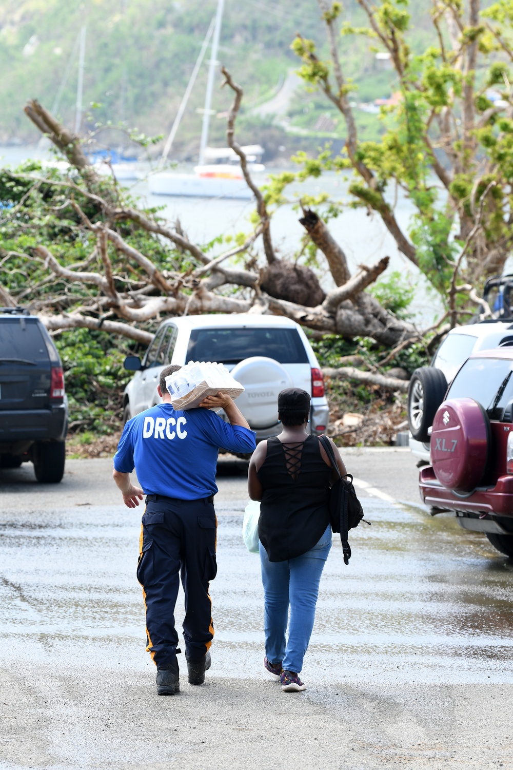 New Jersey Disaster Response Crisis Counselor Carries a Case of Water for Resident