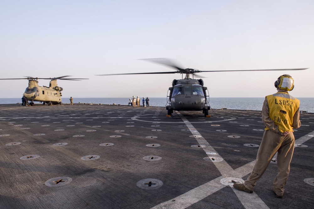 USS Pearl Harbor flight deck personnel launch and recover Army helicopters