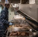 Sailor prepares hamburgers.