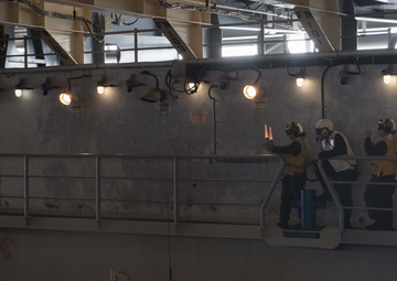 USS Pearl Harbor flight deck personnel launch and recover Army helicopters