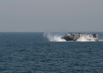 USS Pearl Harbor flight deck personnel launch and recover Army helicopters
