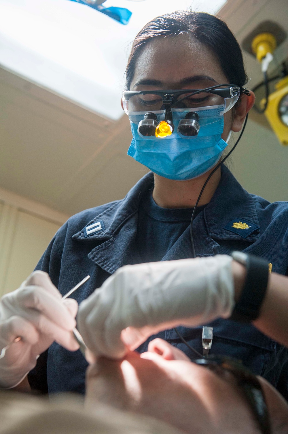 USS America Sailor conducts dental check-up