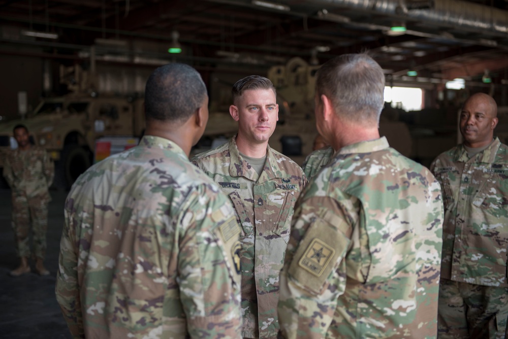 Readiness expert recieves coin from Army Vice Chief