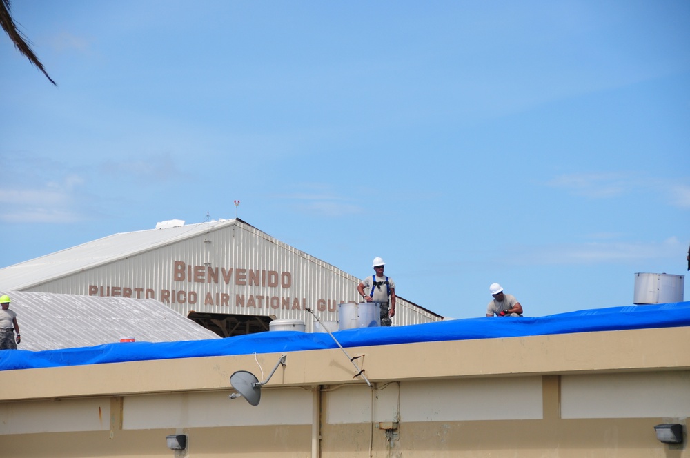 156th Civil Engineering Squadron repair roof with FEMA blue sheets