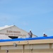 156th Civil Engineering Squadron repair roof with FEMA blue sheets