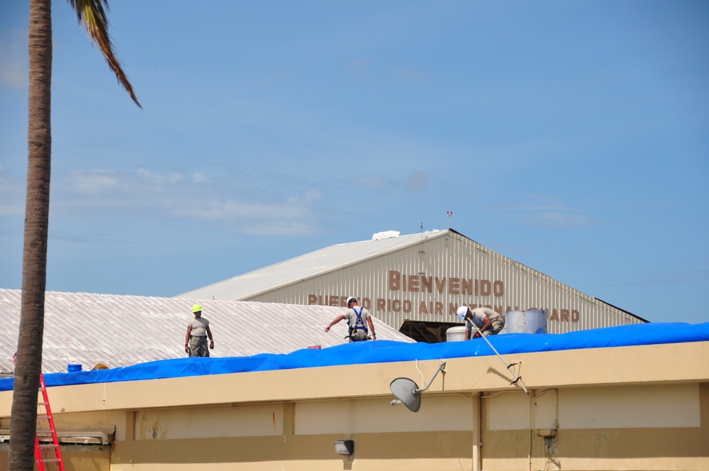 156th Civil Engineering Squadron repair roof with FEMA blue sheets