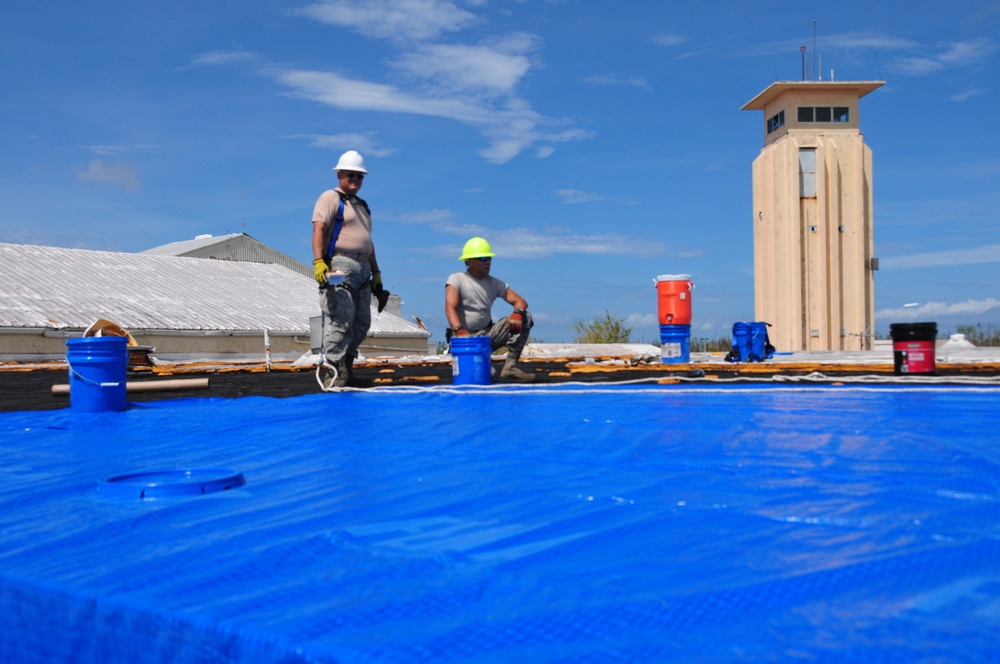 156th Civil Engineering Squadron repair roof with FEMA blue sheets