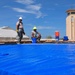 156th Civil Engineering Squadron repair roof with FEMA blue sheets