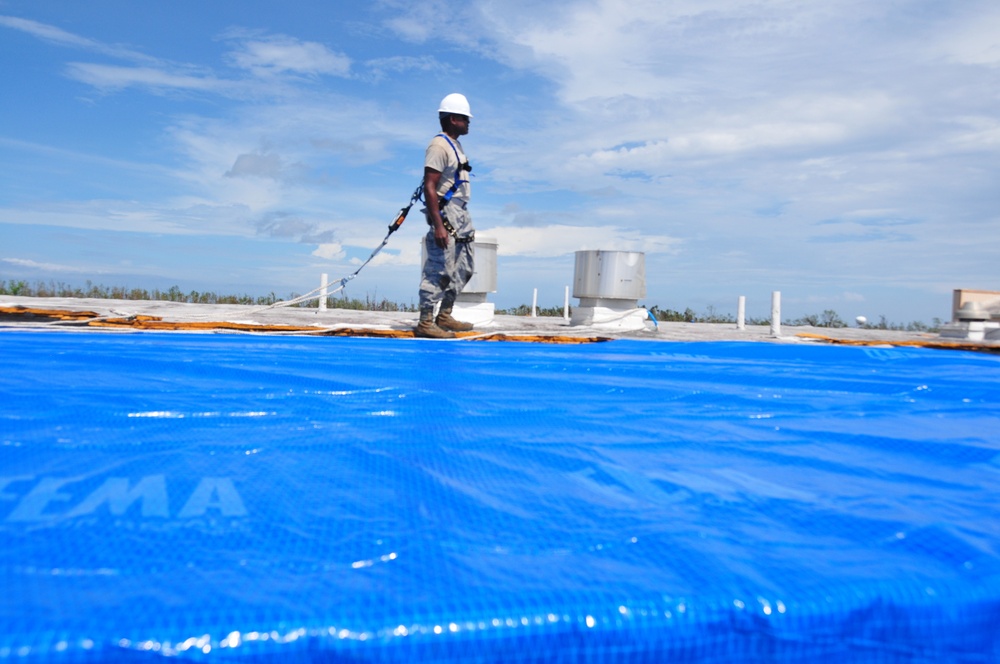 156th Civil Engineering Squadron repair roof with FEMA blue sheets