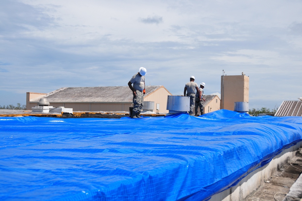 156th Civil Engineering Squadron repair roof with FEMA blue sheets