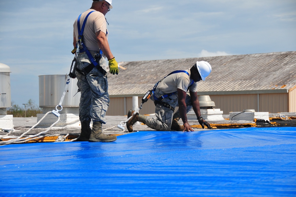 156th Civil Engineering Squadron repair roof with FEMA blue sheets