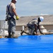 156th Civil Engineering Squadron repair roof with FEMA blue sheets