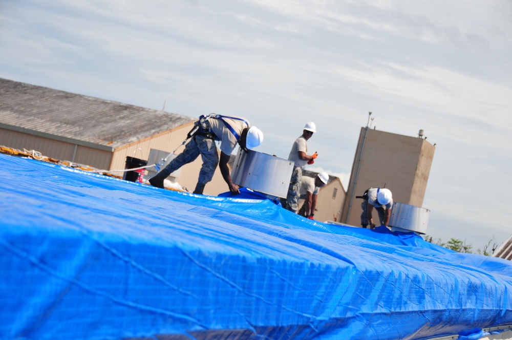 156th Civil Engineering Squadron repair roof with FEMA blue sheets