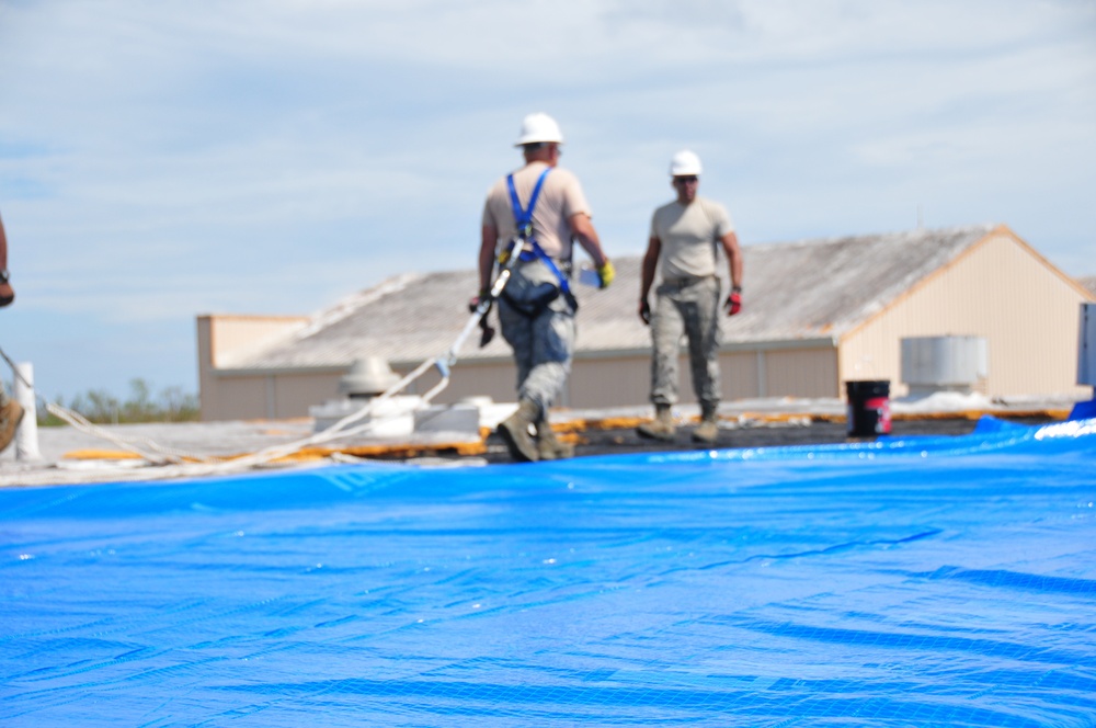 156th Civil Engineering Squadron repair roof with FEMA blue sheets