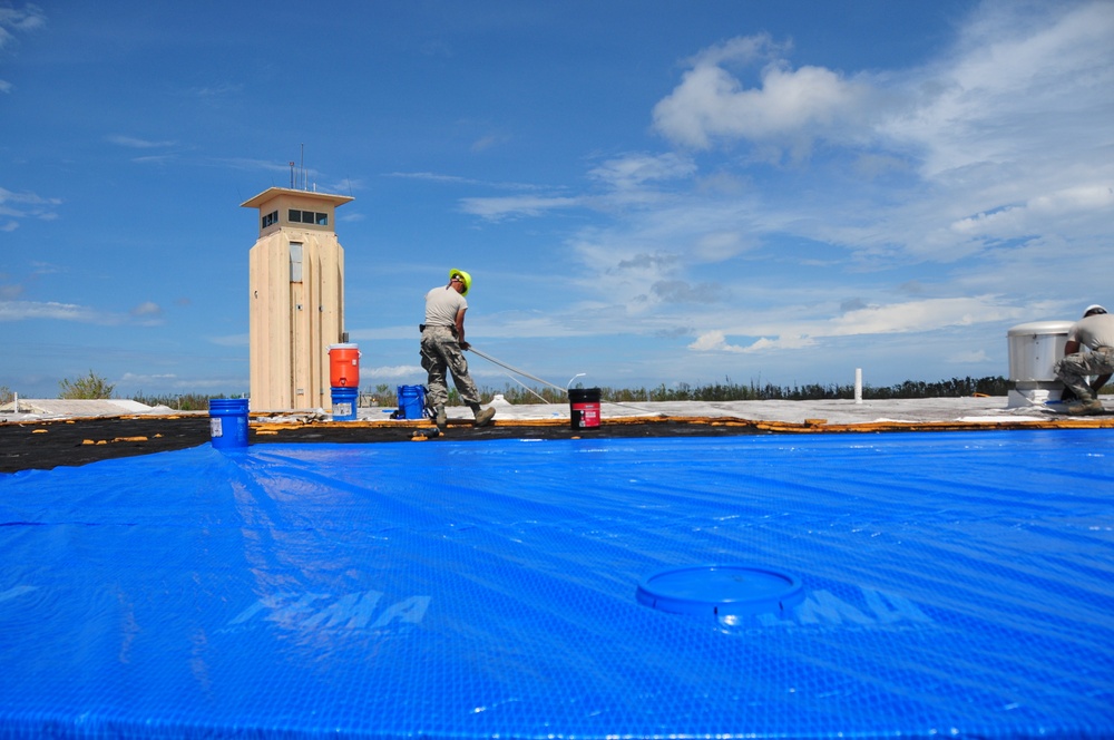 156th Civil Engineering Squadron repair roof with FEMA blue sheets